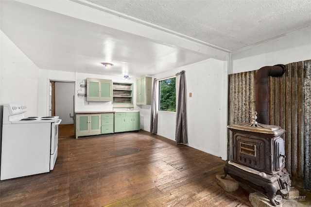 kitchen featuring a wood stove, a textured ceiling, white electric stove, dark hardwood / wood-style floors, and green cabinets