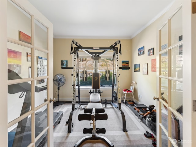 exercise room with ornamental molding and french doors