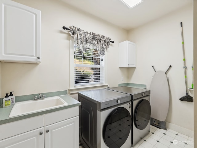 laundry area featuring cabinets, sink, and washing machine and clothes dryer