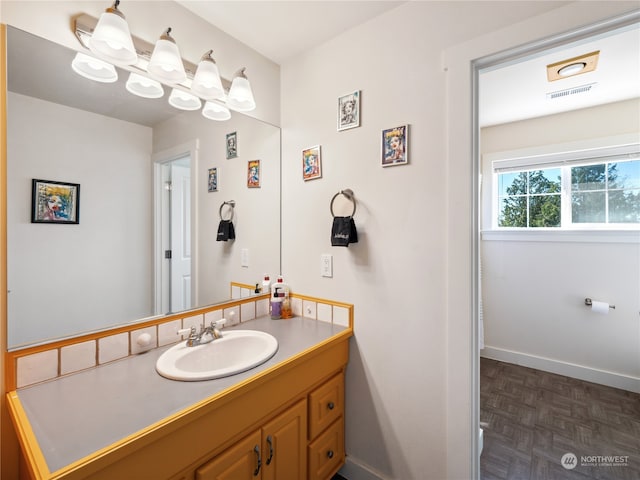 bathroom with vanity and parquet flooring