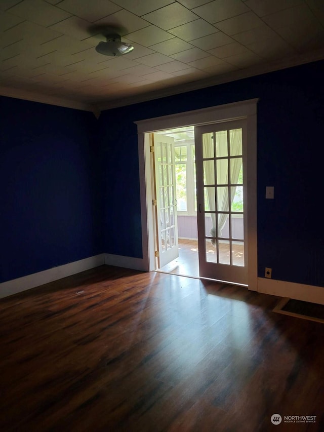 spare room with hardwood / wood-style floors and french doors