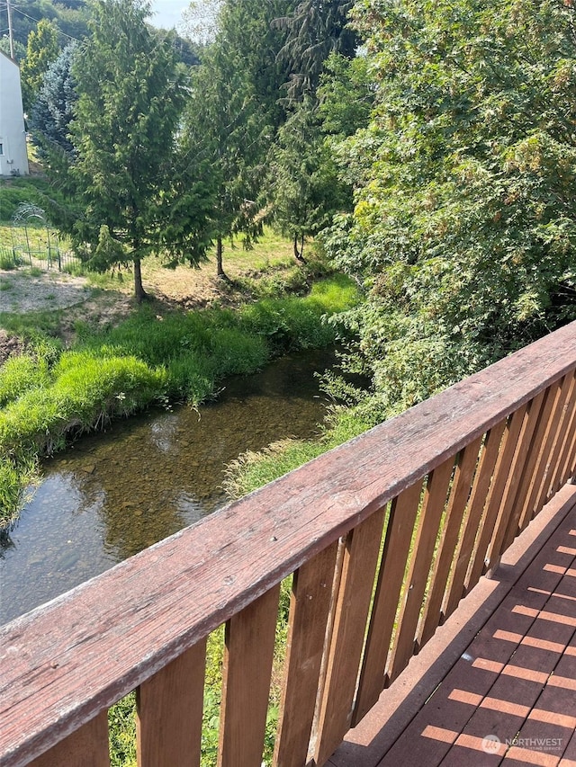 wooden deck featuring a water view