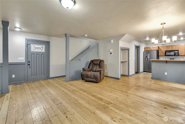 interior space with light hardwood / wood-style flooring and a chandelier