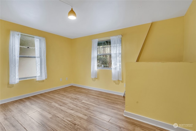 unfurnished room with light hardwood / wood-style flooring