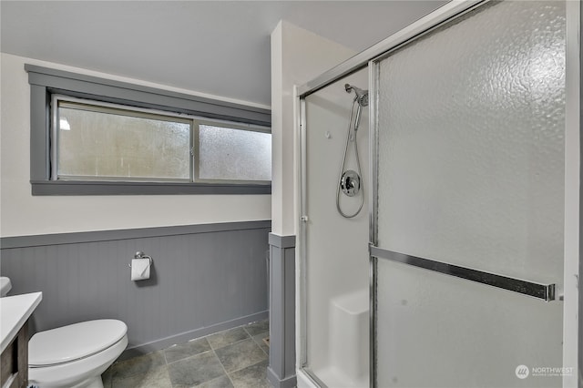 bathroom with toilet, vanity, and walk in shower