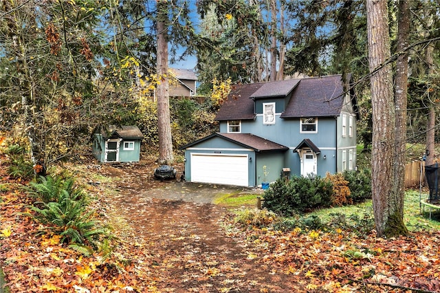 view of front of house featuring a garage and a storage shed