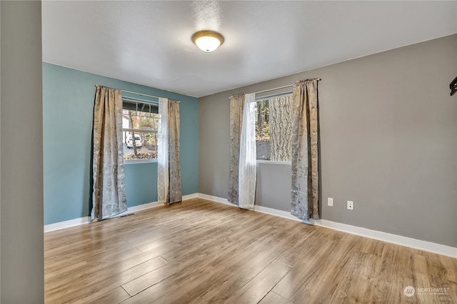 spare room with light wood-type flooring