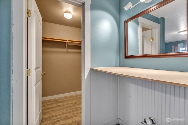 spacious closet featuring light hardwood / wood-style floors