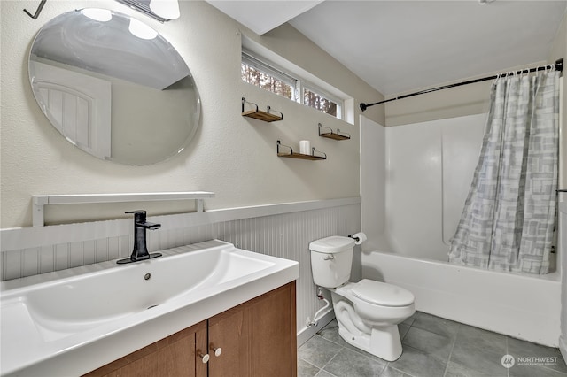 full bathroom featuring toilet, shower / bath combo with shower curtain, vanity, and tile patterned flooring