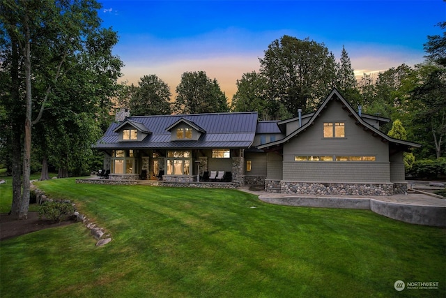 modern inspired farmhouse featuring a lawn