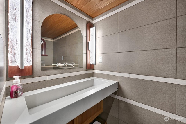 bathroom with tile walls and wooden ceiling