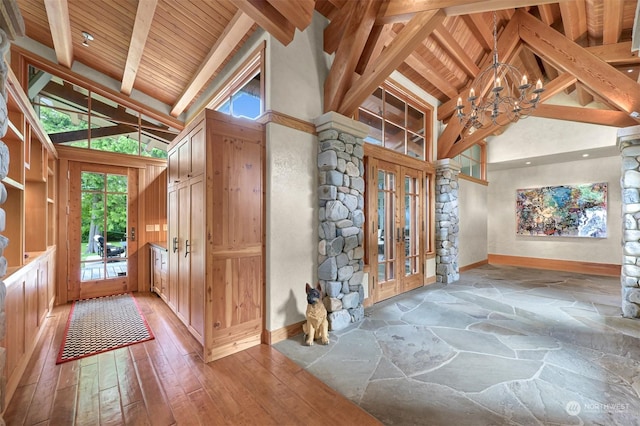 entrance foyer featuring french doors, wood ceiling, wood-type flooring, a notable chandelier, and beamed ceiling