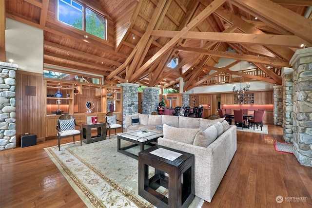 living room featuring hardwood / wood-style flooring, wood ceiling, beam ceiling, and high vaulted ceiling