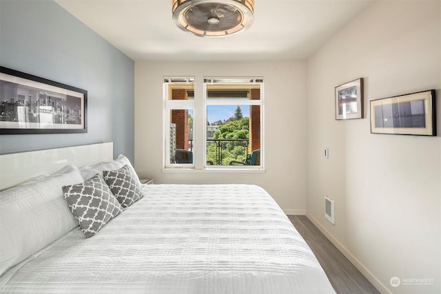 bedroom with hardwood / wood-style flooring