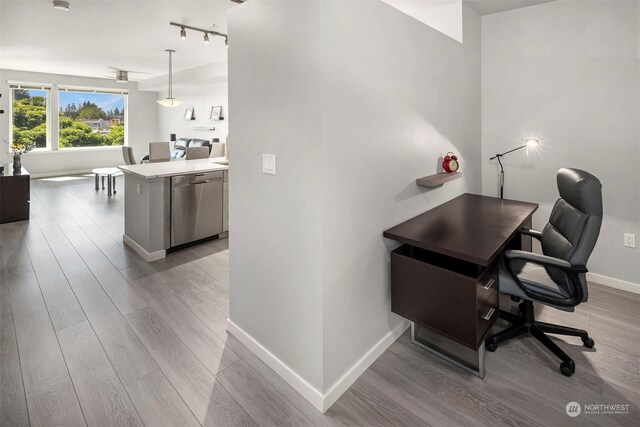 office area featuring rail lighting and hardwood / wood-style floors