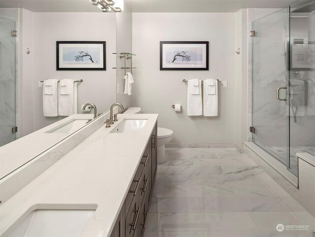 bathroom featuring double sink vanity, toilet, tile patterned flooring, and a shower with shower door