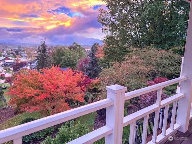 yard at dusk featuring a balcony