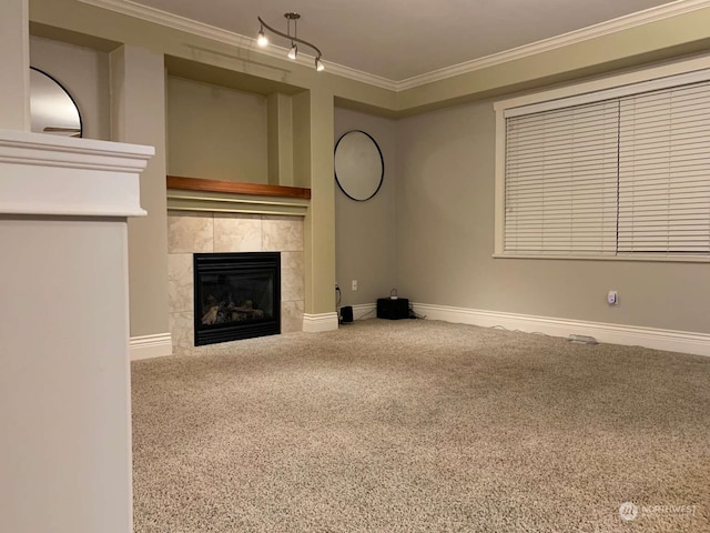 unfurnished living room with a tile fireplace, crown molding, and carpet