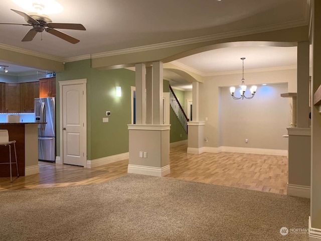 unfurnished living room with ornamental molding, ceiling fan with notable chandelier, and light hardwood / wood-style floors