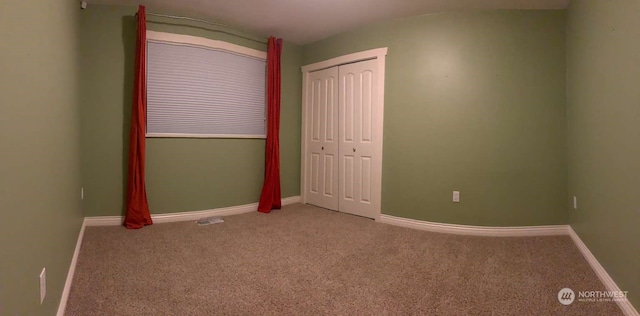 unfurnished bedroom with carpet flooring and a closet