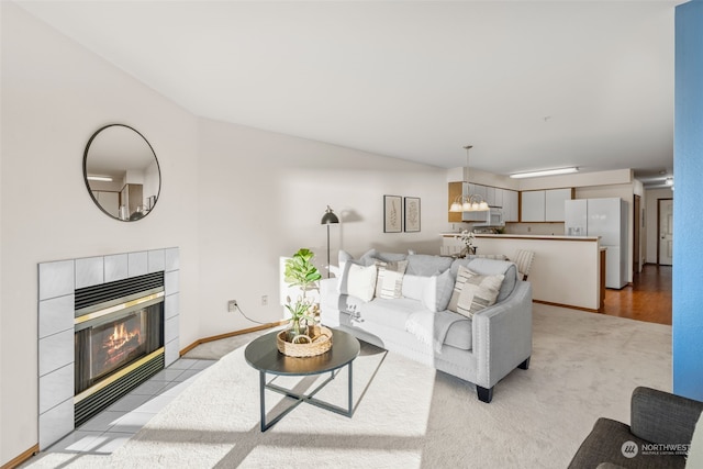 living room featuring a fireplace and light colored carpet