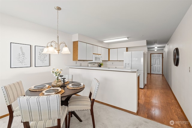 dining area featuring a notable chandelier and light hardwood / wood-style flooring