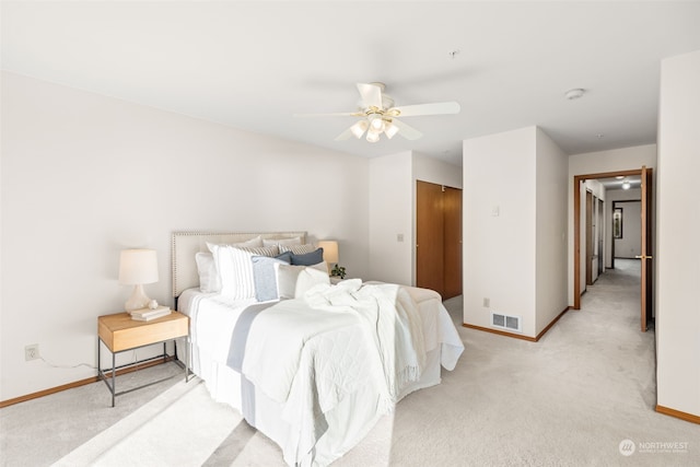 carpeted bedroom with ceiling fan and a closet