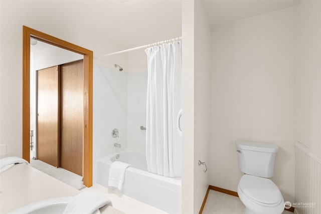 bathroom with toilet and shower / bath combo with shower curtain