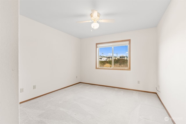 unfurnished room with light colored carpet and ceiling fan