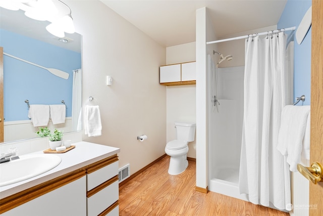 bathroom with vanity, a shower with curtain, wood-type flooring, and toilet