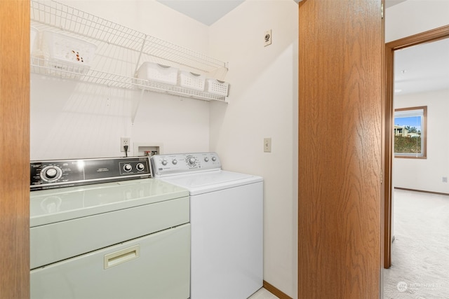 washroom featuring light colored carpet and washing machine and clothes dryer