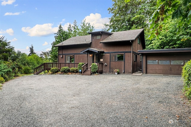 view of front of home featuring a garage and a deck