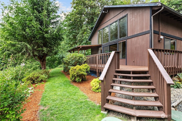 exterior space with a wooden deck and a yard