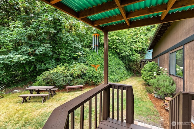 wooden terrace featuring a lawn