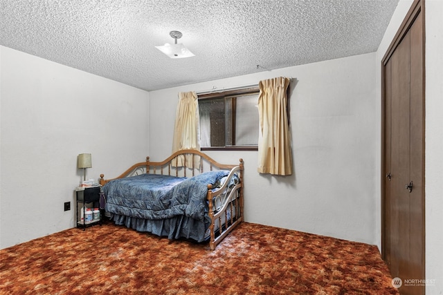 carpeted bedroom featuring a closet and a textured ceiling