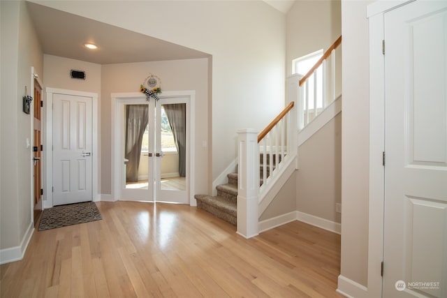 entryway featuring light wood-type flooring and french doors