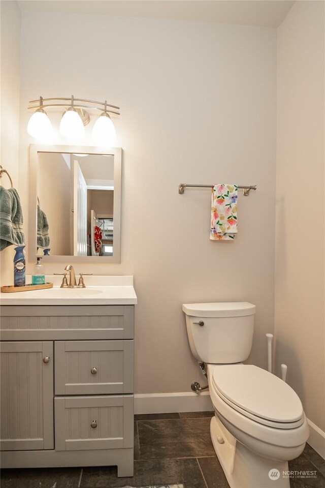 bathroom with vanity, tile patterned flooring, and toilet