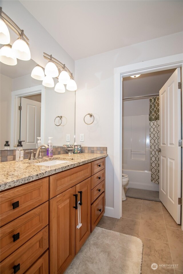 full bathroom with shower / bath combo, tile patterned floors, vanity, and toilet