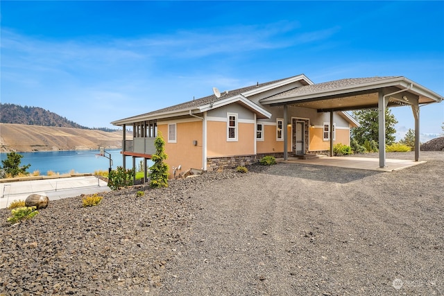 view of front of property with a water and mountain view