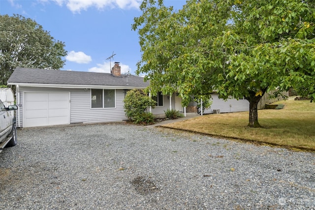 view of front of home featuring a garage and a front lawn