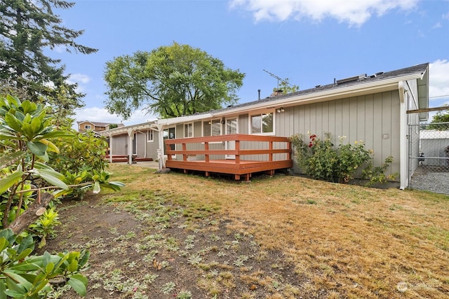 back of house featuring a yard and a deck