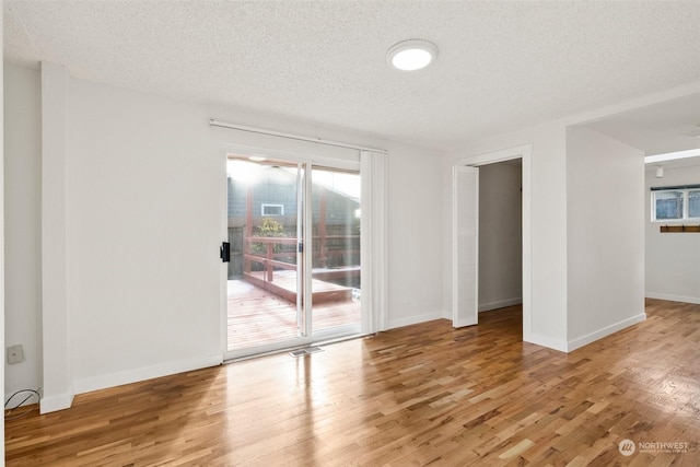 spare room with hardwood / wood-style flooring and a textured ceiling