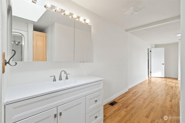 bathroom featuring vanity and hardwood / wood-style floors