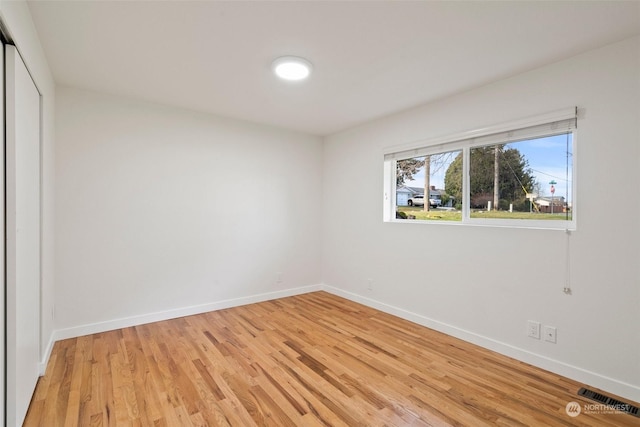 spare room with light wood-type flooring