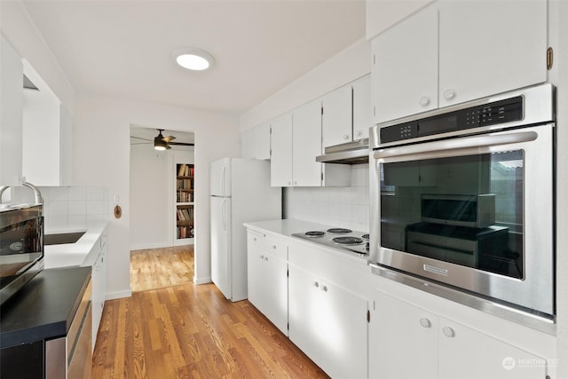 kitchen featuring decorative backsplash, white cabinets, white appliances, and light hardwood / wood-style floors