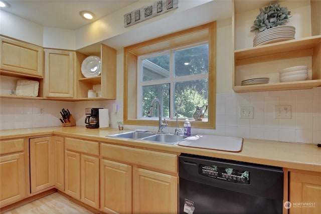 kitchen featuring tasteful backsplash, sink, light brown cabinetry, and black dishwasher