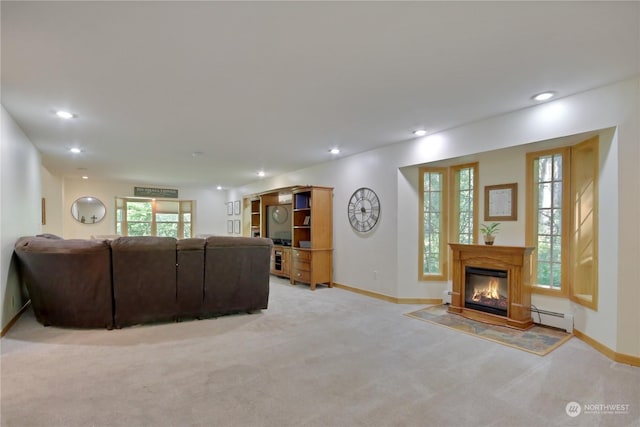 carpeted living room featuring a baseboard heating unit