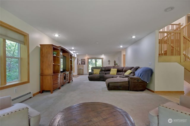 living room with light carpet and a baseboard heating unit