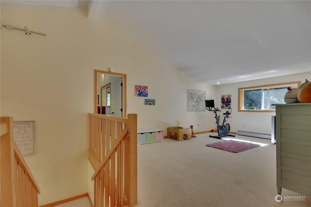 exercise room featuring a baseboard radiator, carpet floors, and high vaulted ceiling