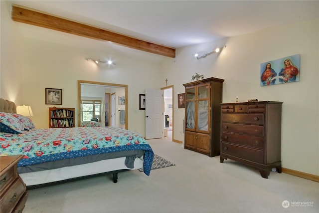 carpeted bedroom with vaulted ceiling with beams